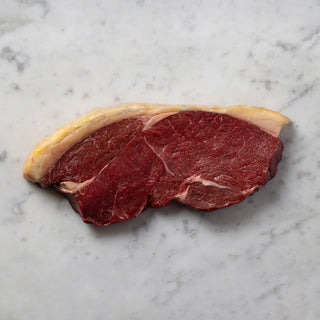 Raw steak on a marble surface