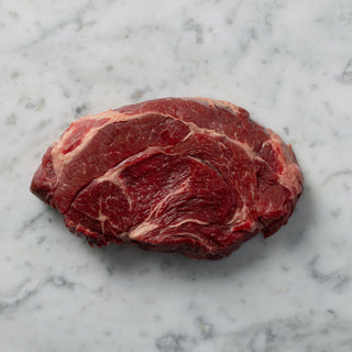 piece of chuck steak on white marble