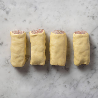 4 sausage rolls on white marble