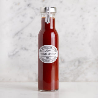 Bottle of tomato ketchup with a label on a marble background